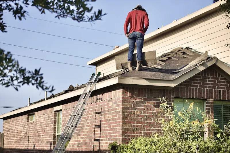 Professional roofer working on a residential roof in Sawgrass Lakes